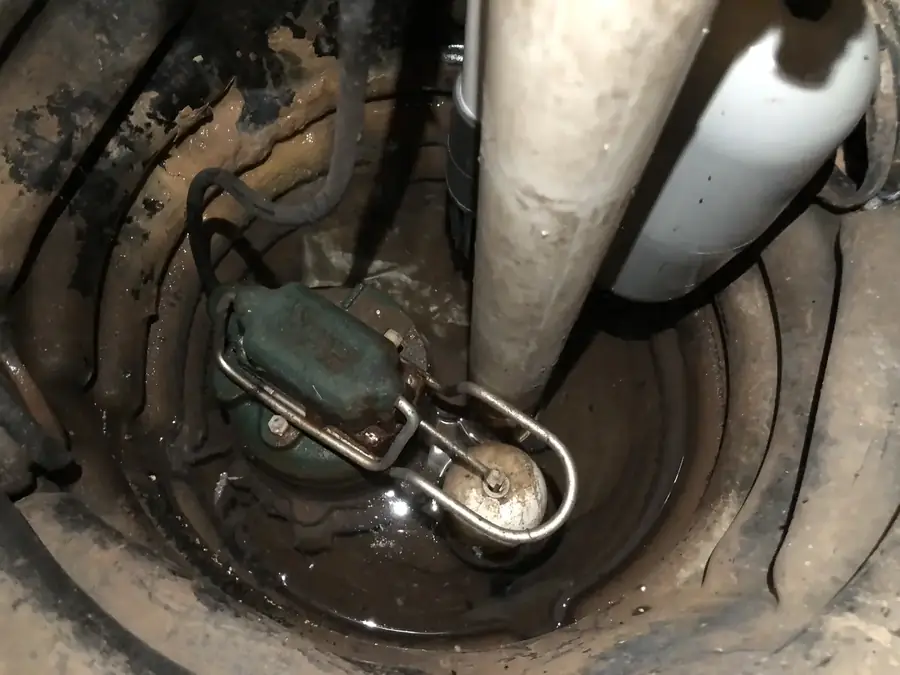 Sump pump and float switch installed in a basement sump pit in McDonough GA